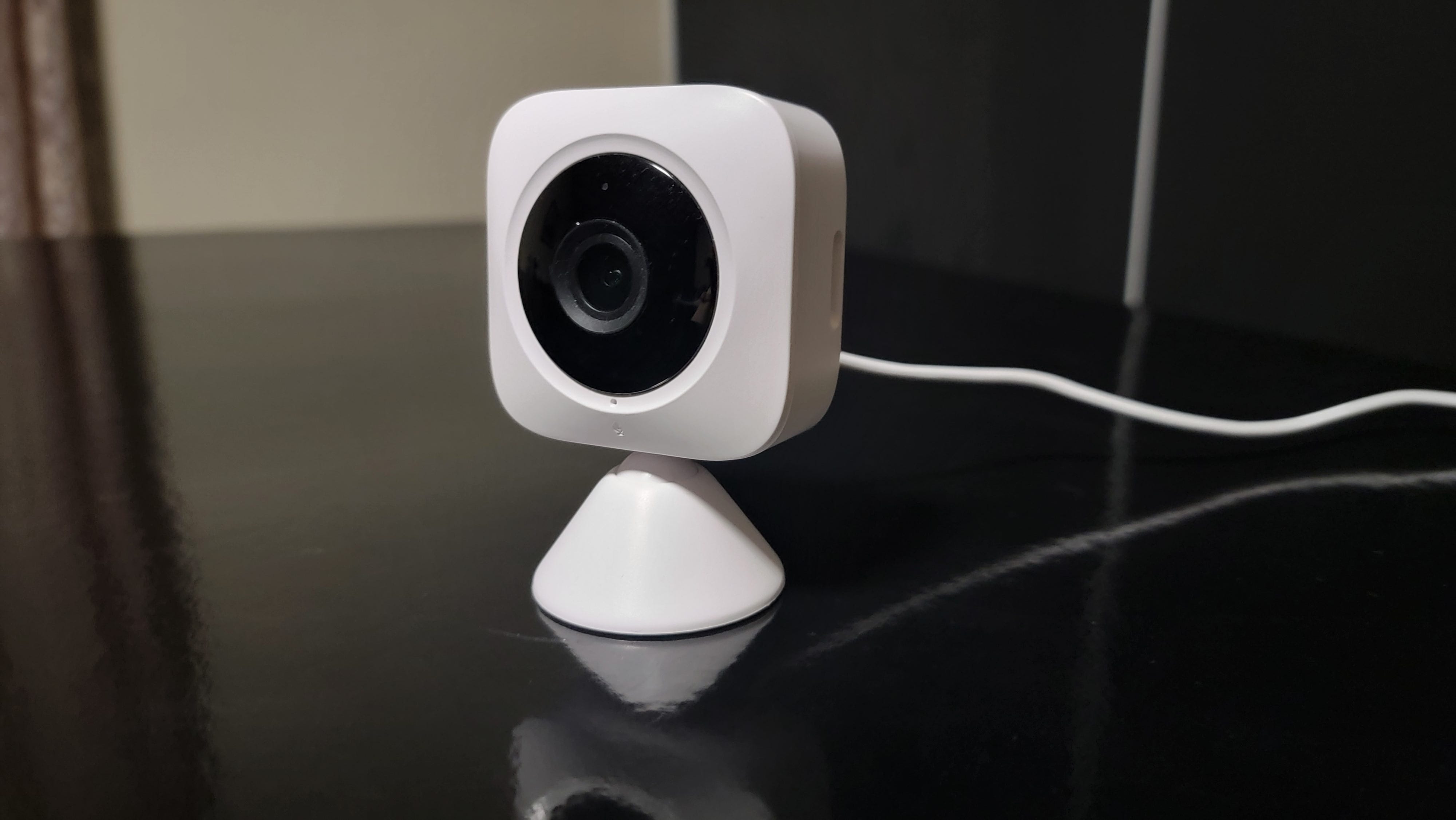 Switchbot Indoor Security camera facing left on black surface