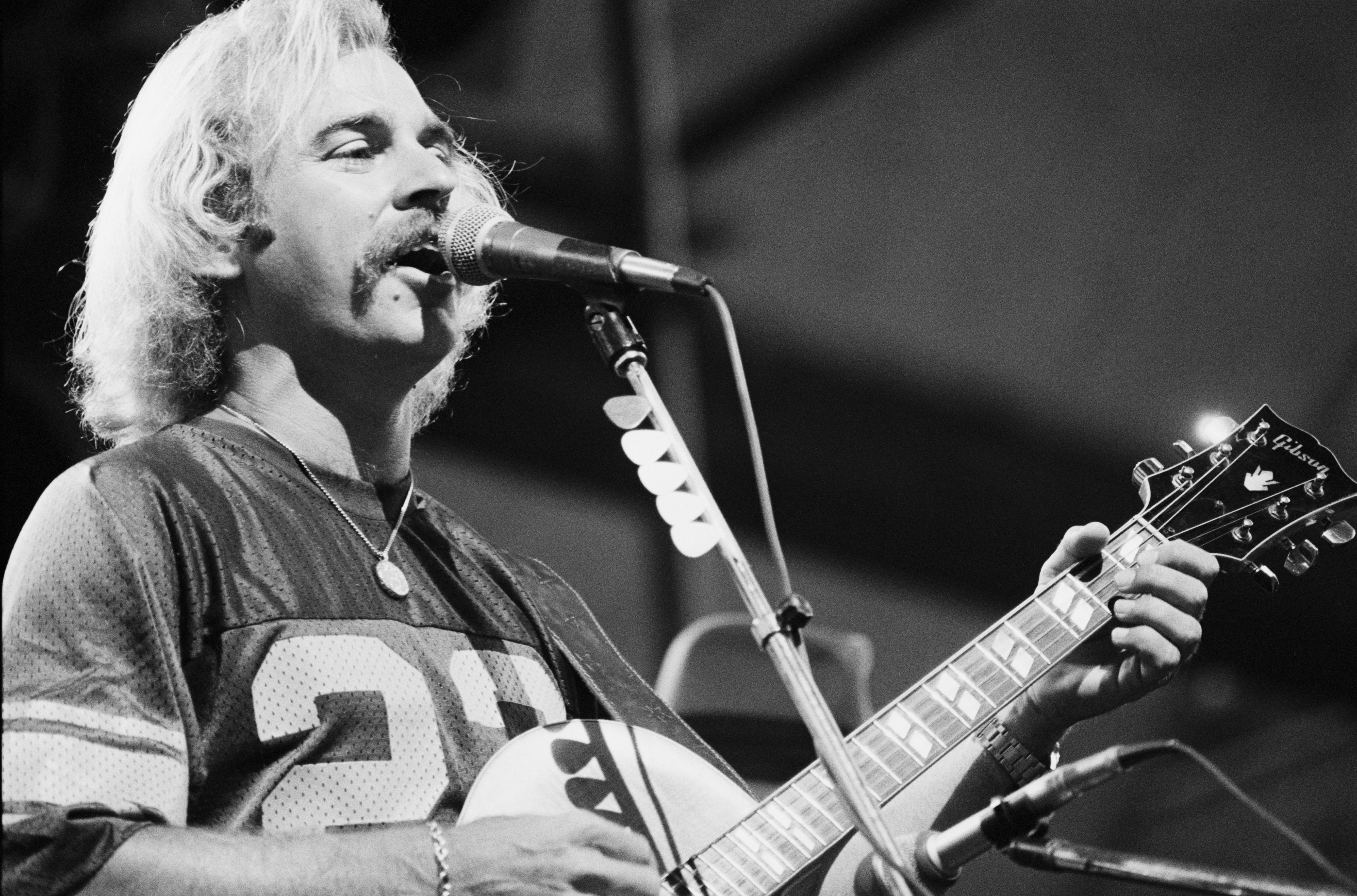 jimmy buffett onstage in the 70s in black and white