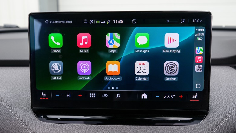 A vehicle's infotainment screen showing the Home screen of Apple CarPlay