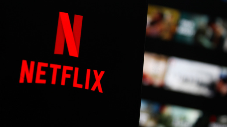 Netflix displayed on a smartphone with its homescreen visible in the background