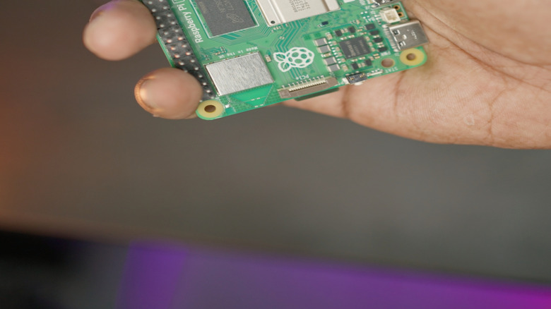 Hand holding Raspberry Pi board