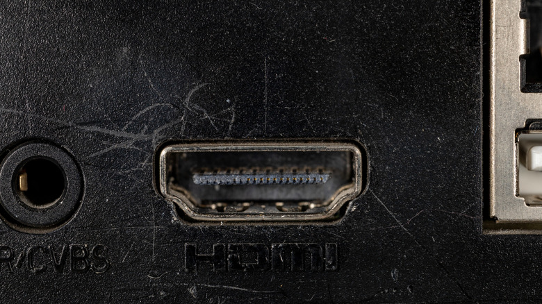 An old, dusty HDMI port on the back of a device.