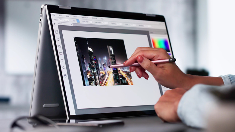 Affinity icon on a computer screen with Canva app view displayed on mobile.