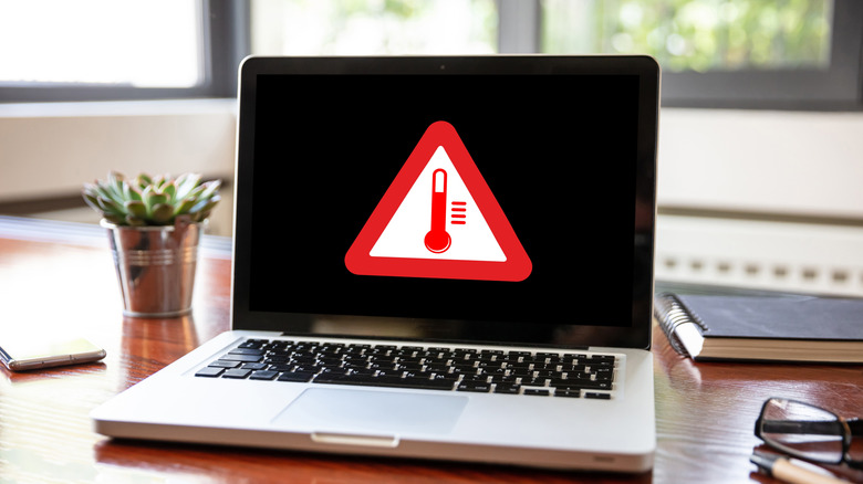 Laptop with temperature warning sign