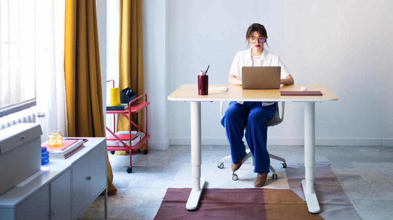 A woman at her desk.