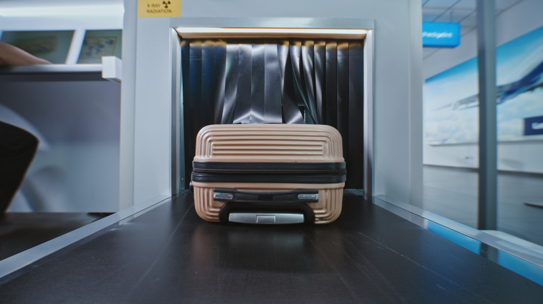 A carry-on bag undergoing security screening