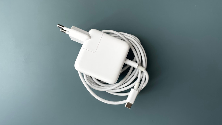 A white power adapter with an attached charging cable