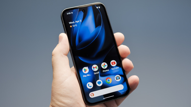 A hand holding the Google Pixel 9a.