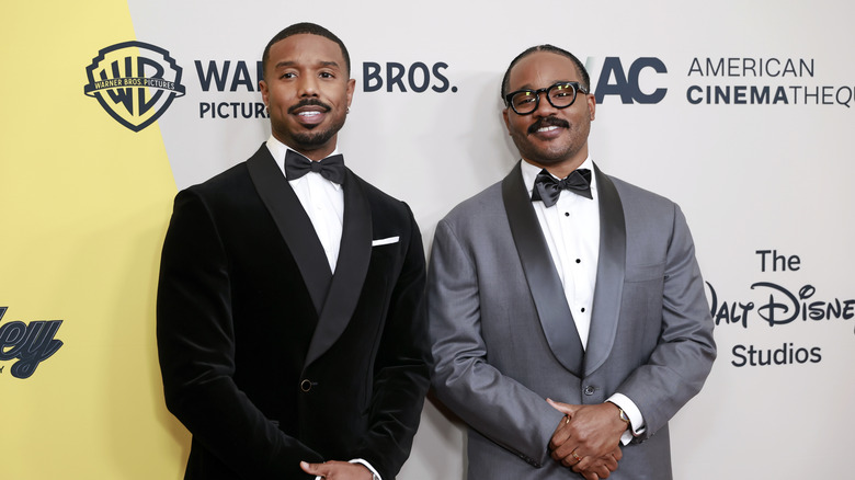 A photo of actor Micheal B. Jordan and director Ryan Coogler, both dressed in tuxedos standing next to each other, at an award ceremony.