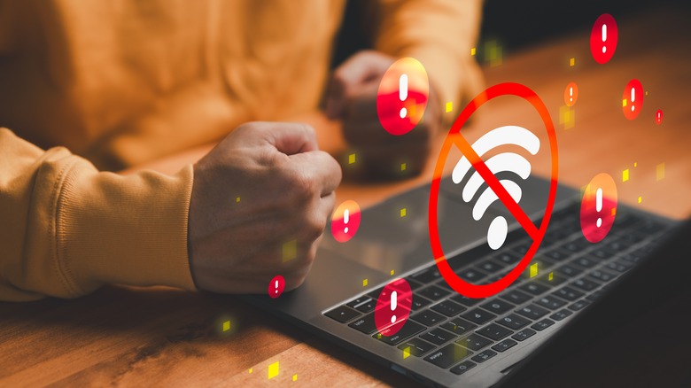 Frustrated user with laptop facing Wi-Fi disconnection