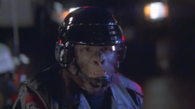 An actor dressed as an ape from the 2001 film 'Planet of the Apes,' the ape/human-hybrid is wearing a black helmet and what seems to be a uniform