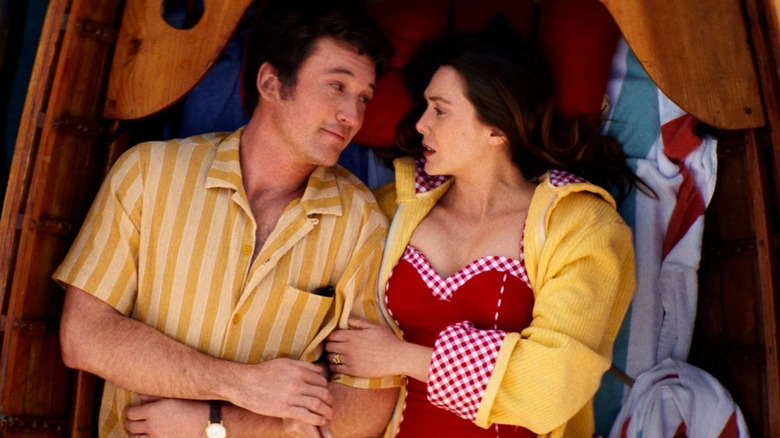 Larry and Joan reclining while gazing at each other in a boat