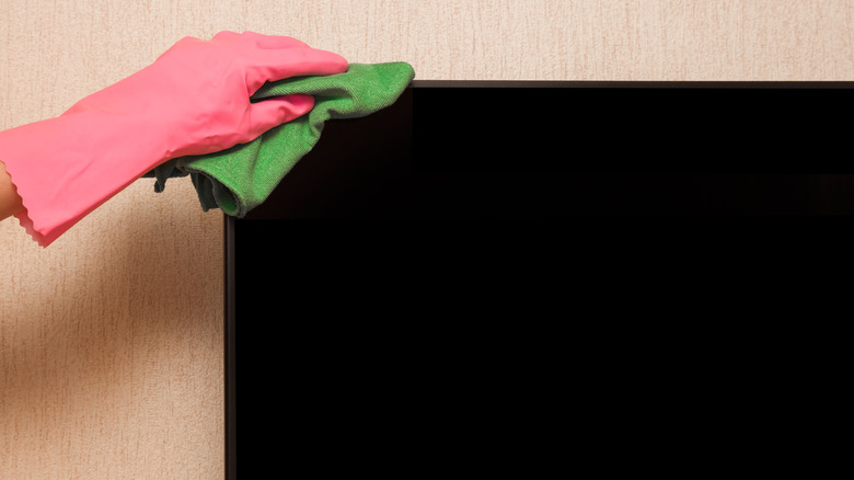 Cleaning an OLED display screen carefully.