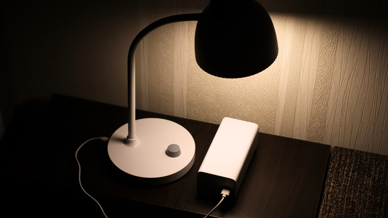 USB powered lamp connected to a power bank on a nightstand