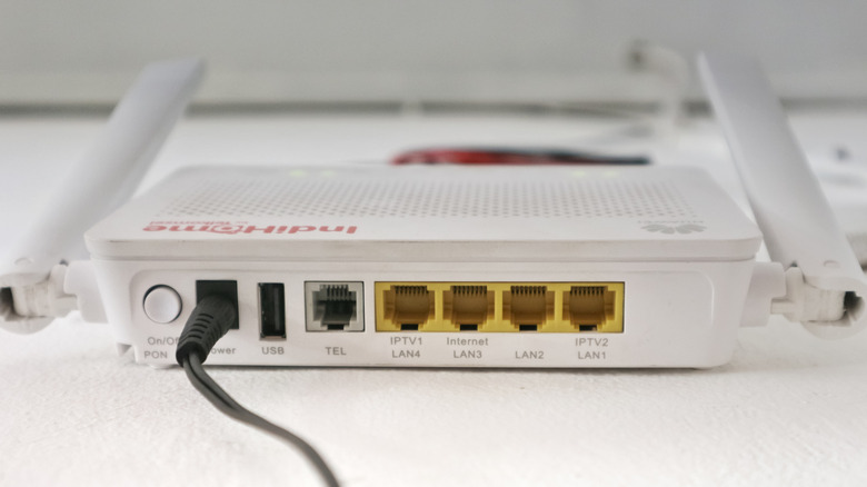 white indihome router showcasing the USB, TEL, and LAN ports