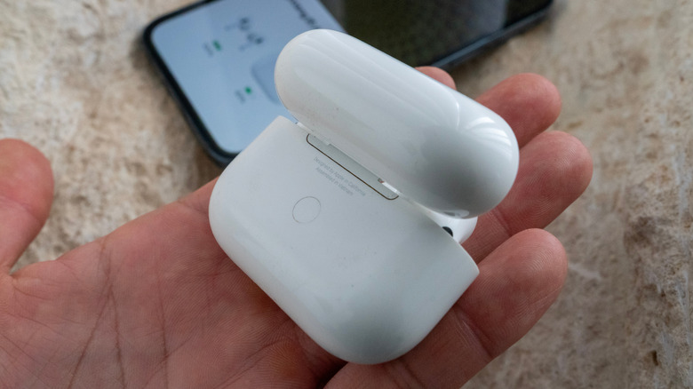 Back of an AirPods charging case in someone's hand