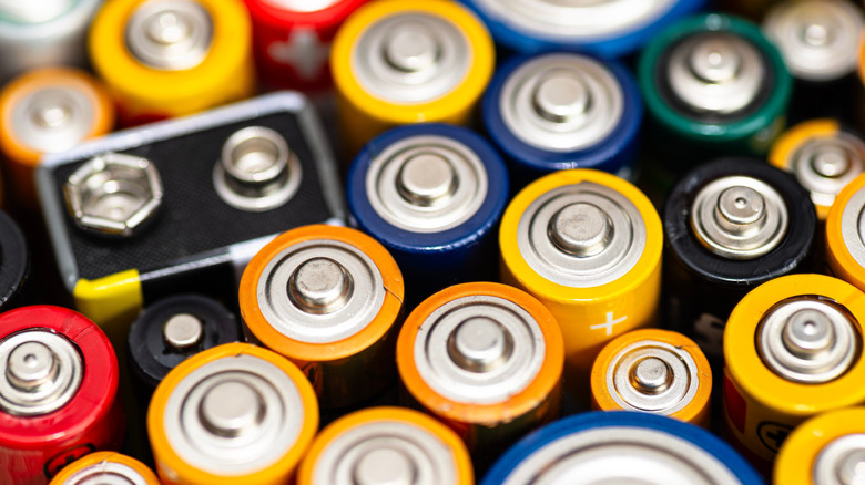 The tops of various size batteries in assorted colors.