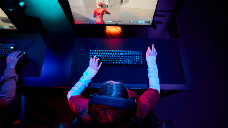 Individual engaging in a video game on a computer.