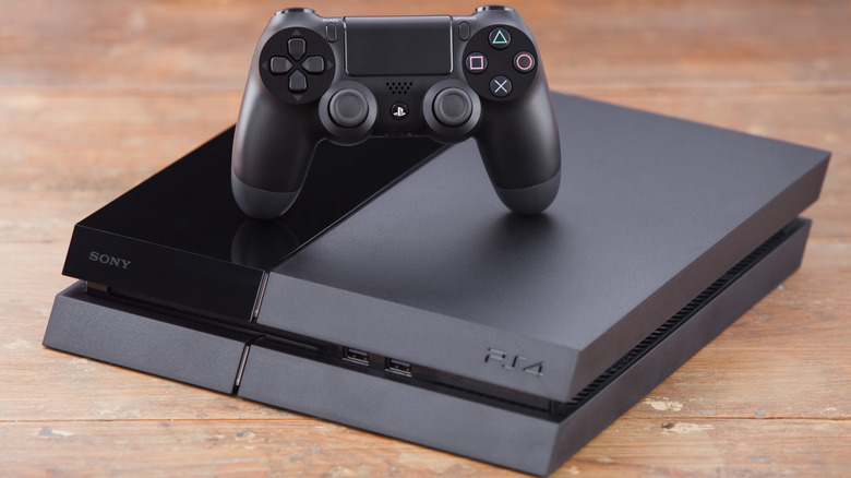 PlayStation 4 console with DualShock controller on top.