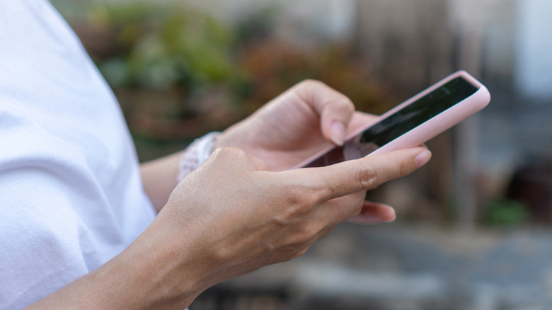 a person interacting with a standard smartphone