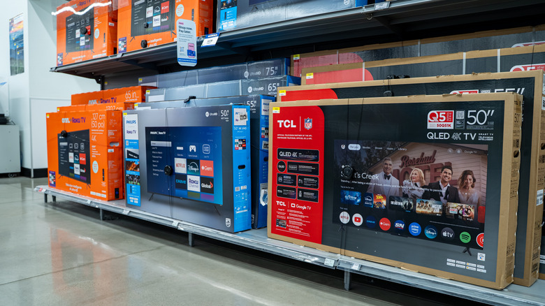Various smart TVs on display in a store.