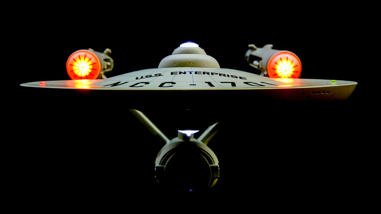 A front view of the U.S.S. Enterprise against a dark background.