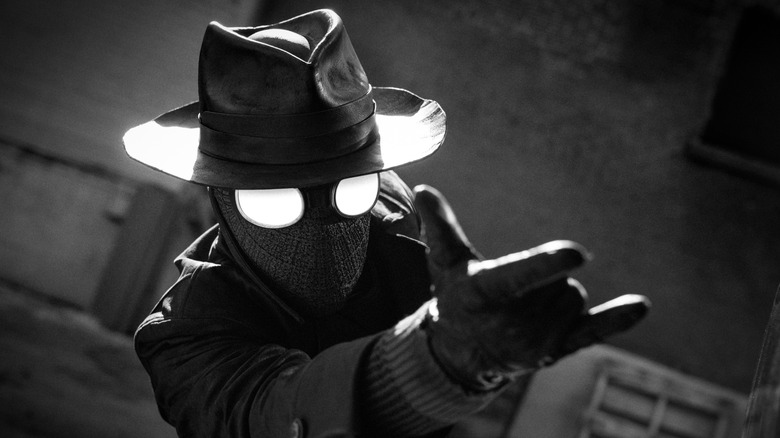 Spider-Noir (Nicolas Cage) preparing to shoot a web.