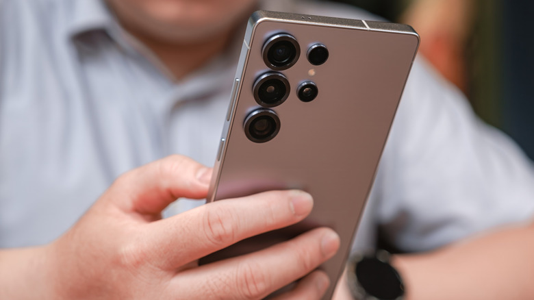 A person holding a Samsung Galaxy S25 Ultra in their grip