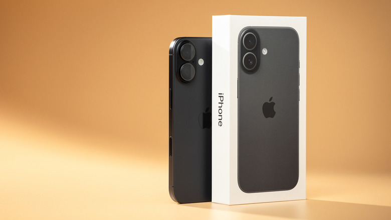 iphone 17 next to its packaging box on a warm backdrop